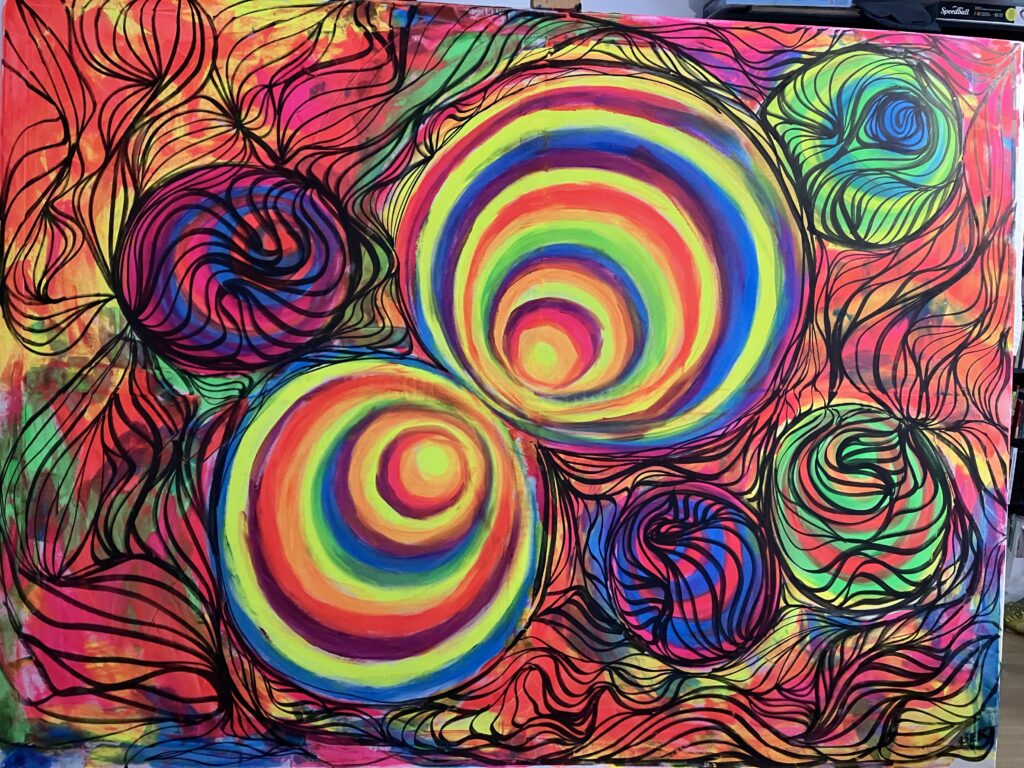  colourful spirals and circles are slowly created, finally black doodle-like lines are made on the image, two spiral-like balls in the middle remain free. 